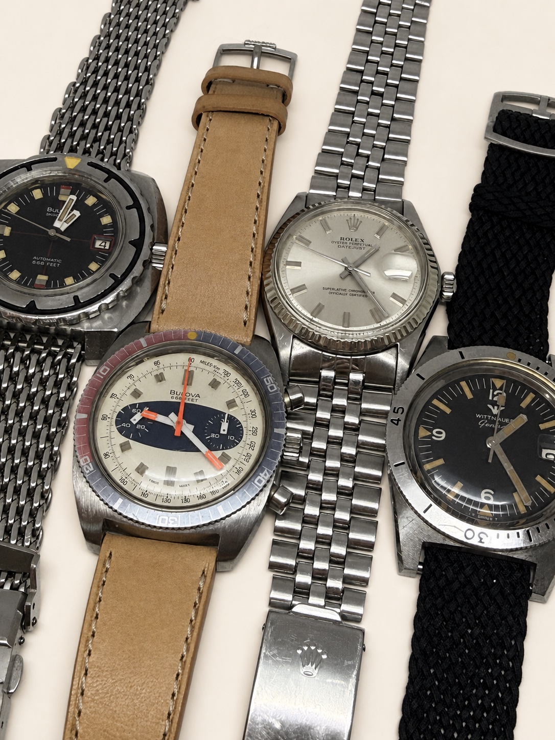 A collection of restored vintage mechanical watches with leather and metal bracelets